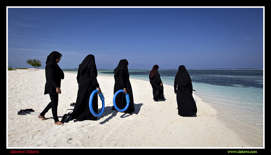 Women go bathing in Maafushi, Maldives