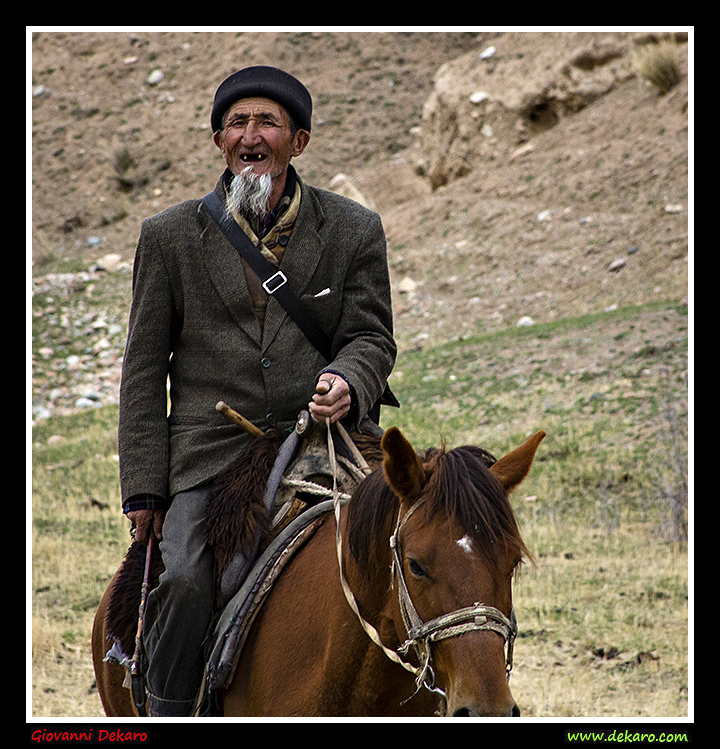 Old man riding in Kyrgyzstan